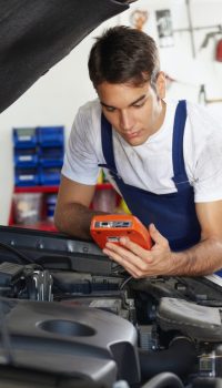young-man-working-as-mechanic-repairing-car-engine-682x1024
