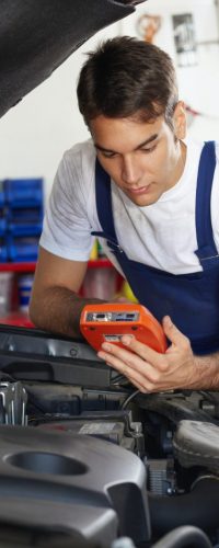 young-man-working-as-mechanic-repairing-car-engine-682x1024